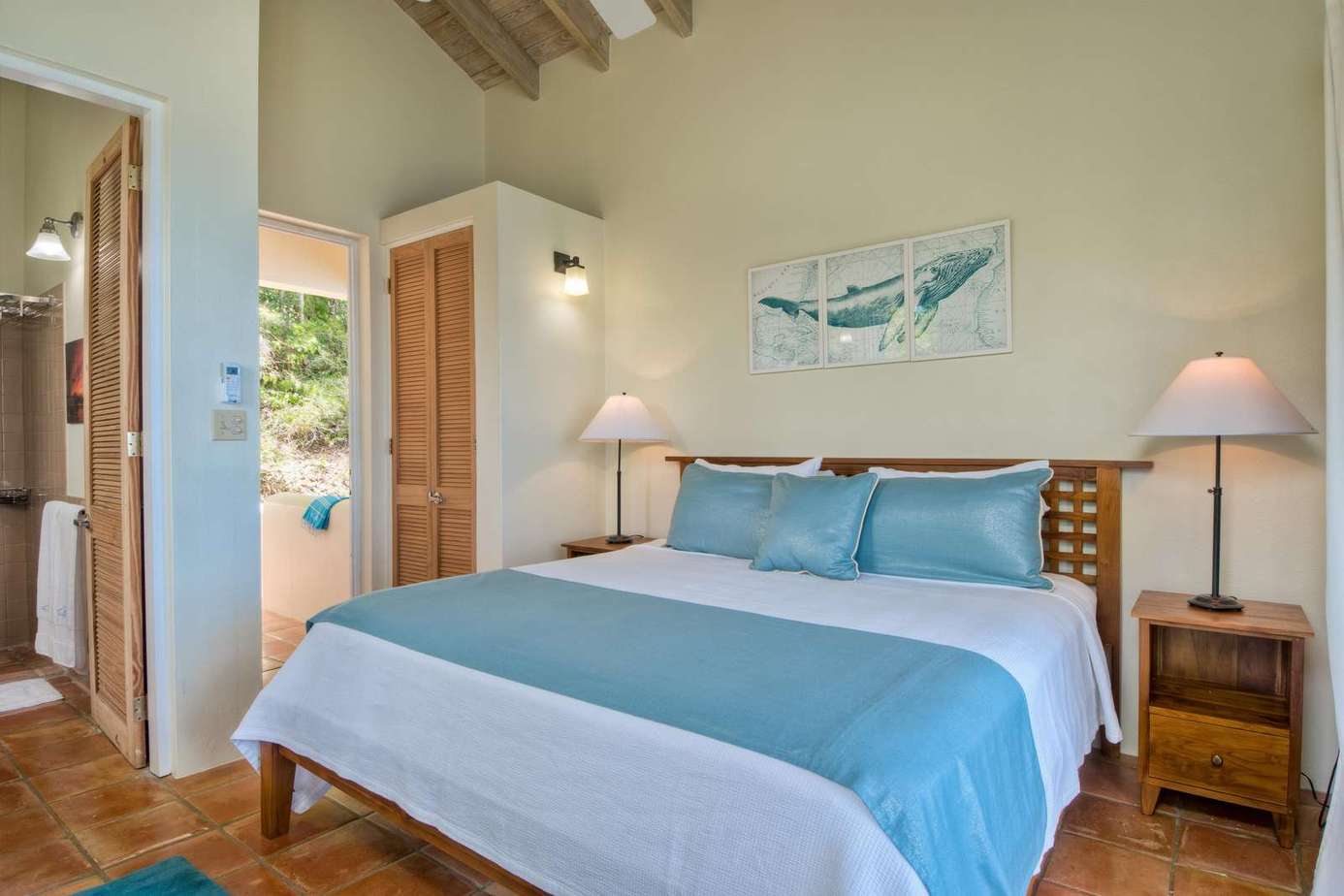 Cozy bedroom retreat with vaulted ceilings and natural light