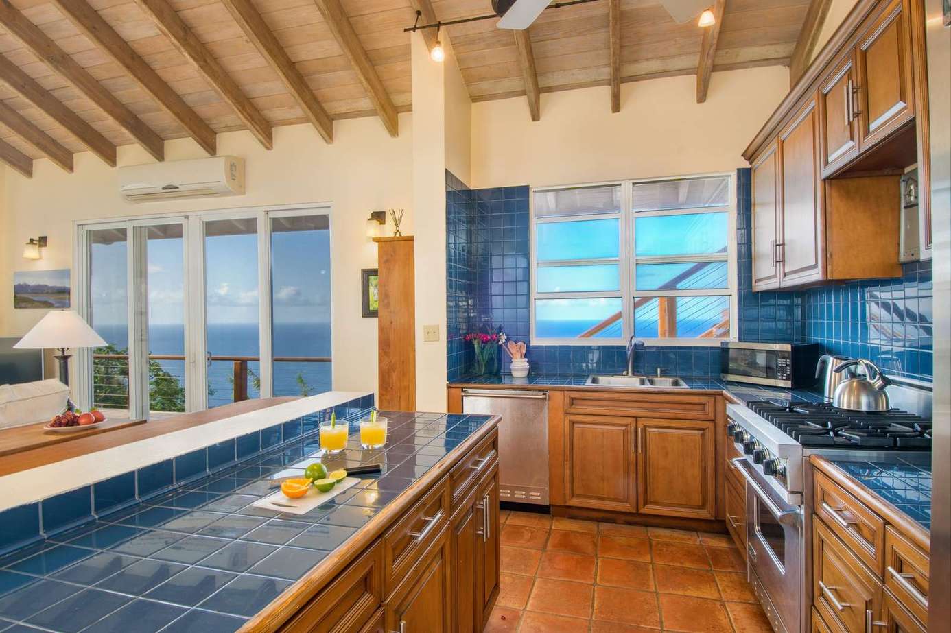 Sunlit kitchen with ocean views and rustic charm