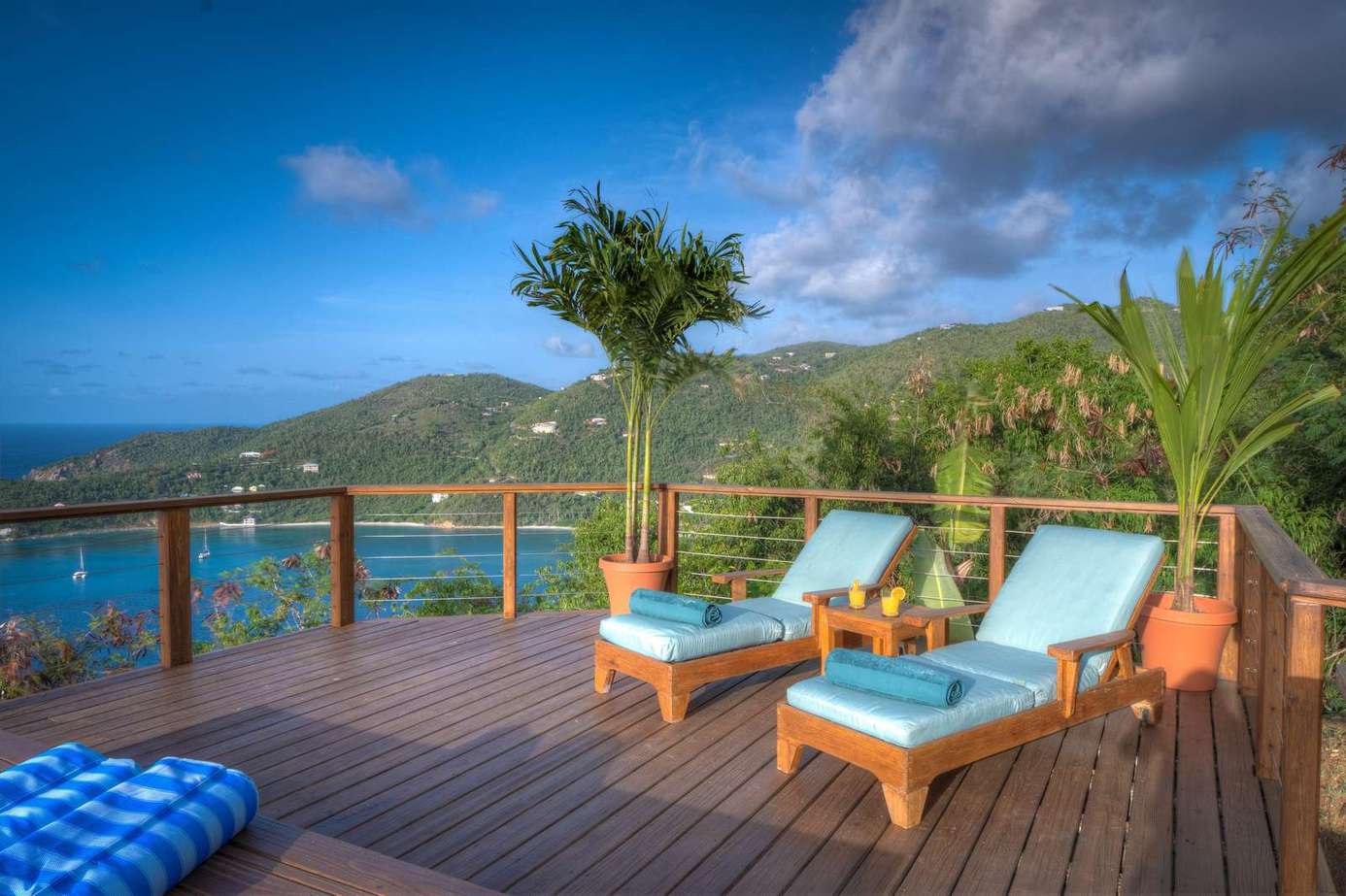 Sun-drenched deck with panoramic ocean and mountain views