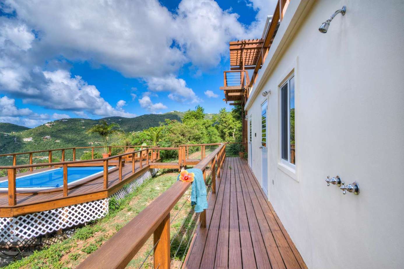Sunlit deck with panoramic mountain and pool views