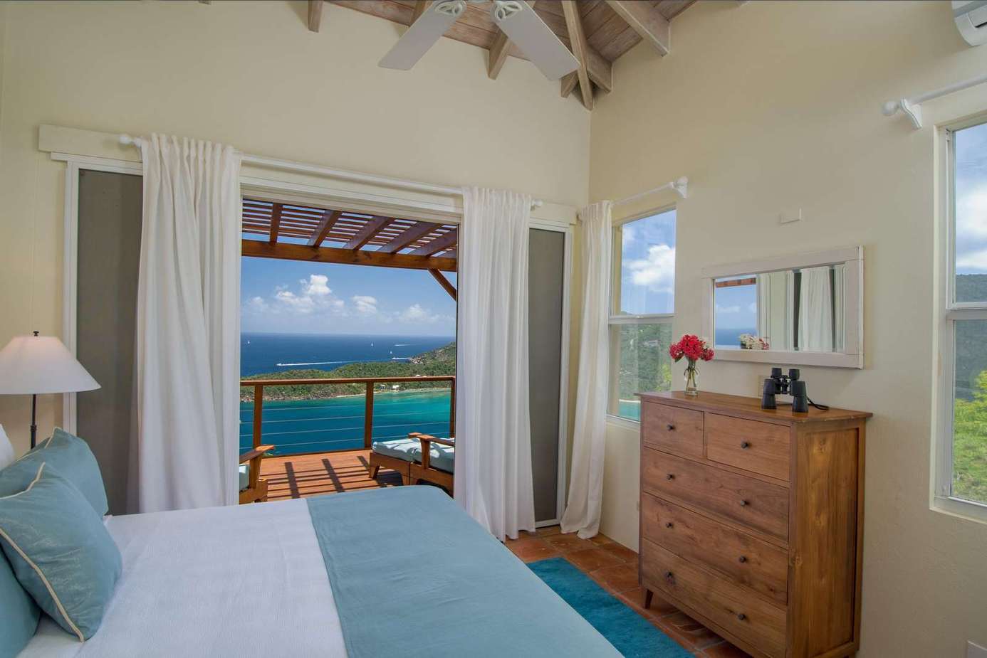 Ocean-view bedroom with airy ceilings and natural light