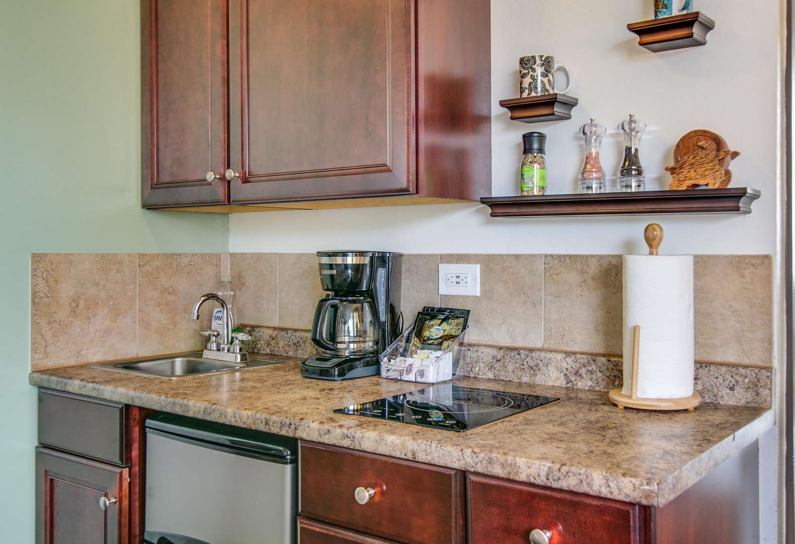 Granite counter over fridge and utensil storage