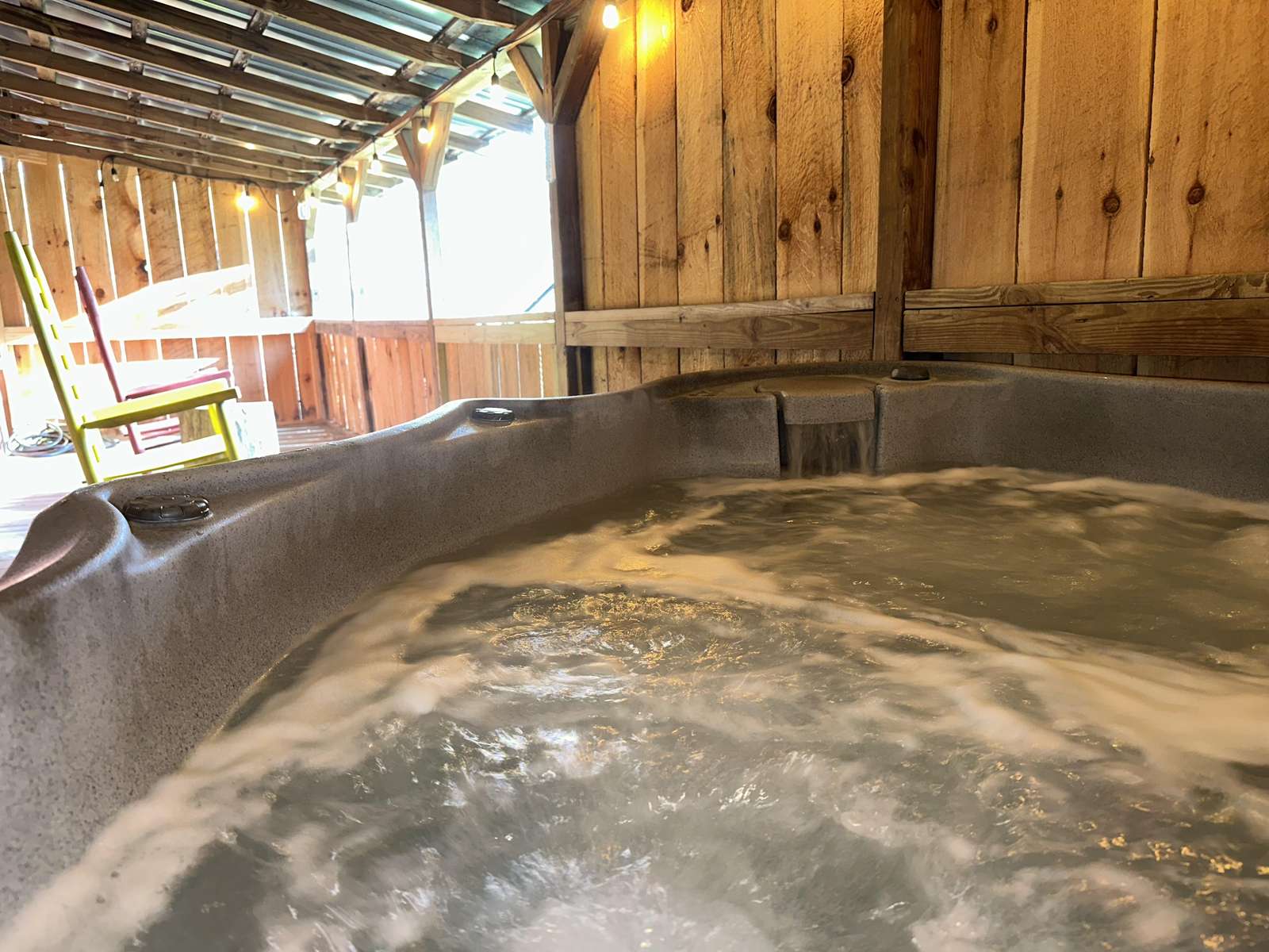 Relax in the bubbling outdoor hot tub under a cozy wooden canopy - property