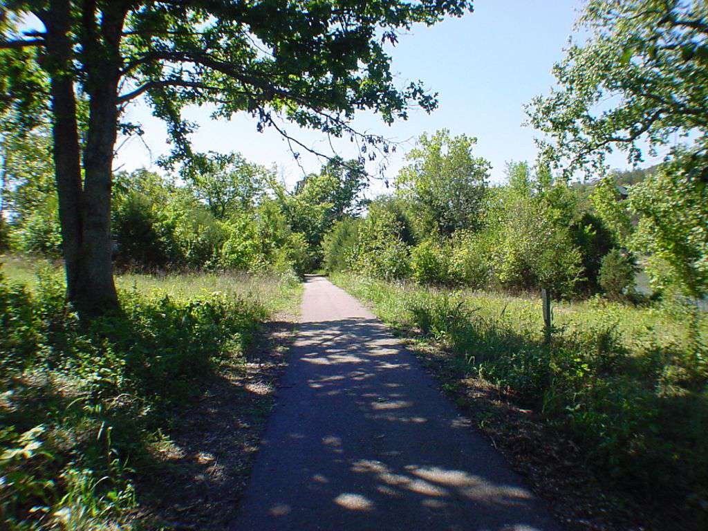 Paved walking trail at the edge of the yard.