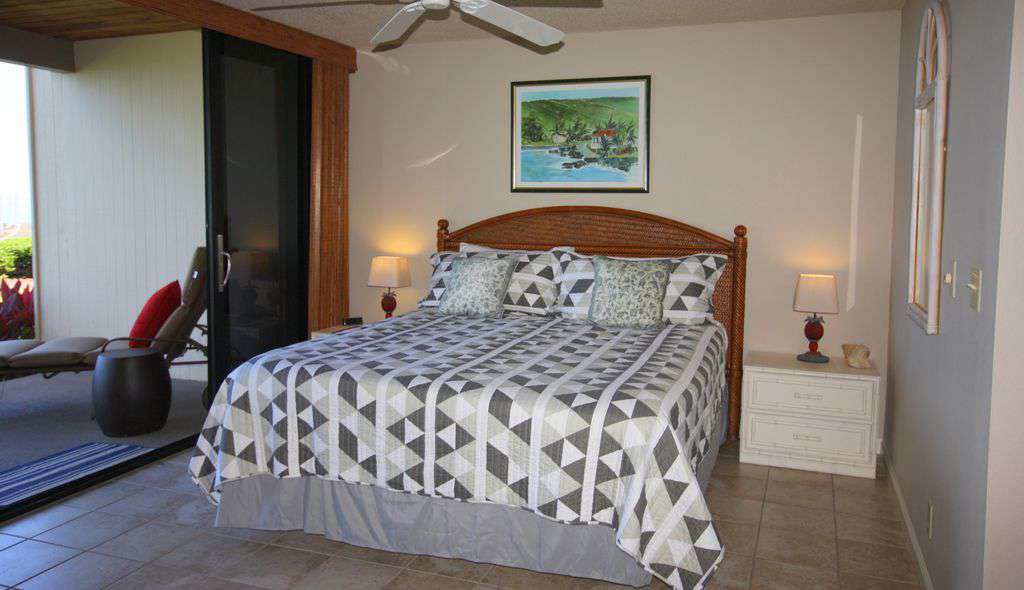 Master bedroom, king bed and sliders to the lanai, with ocean views.