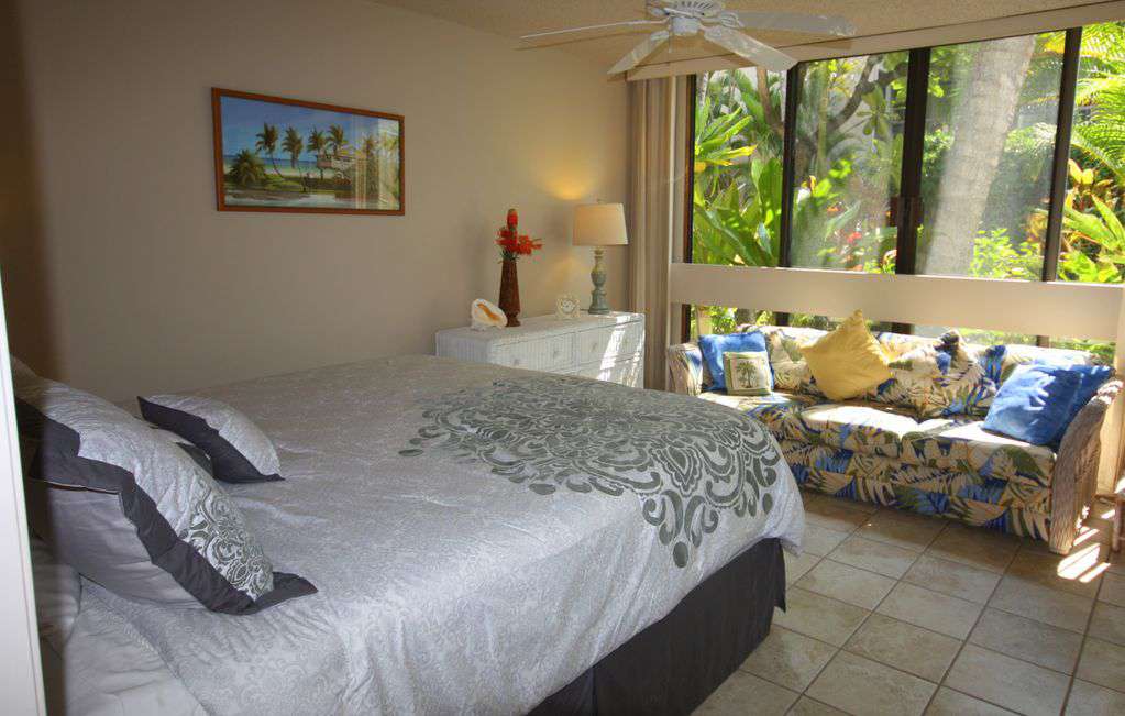Guest bedroom has huge slider windows to let in the breeze.