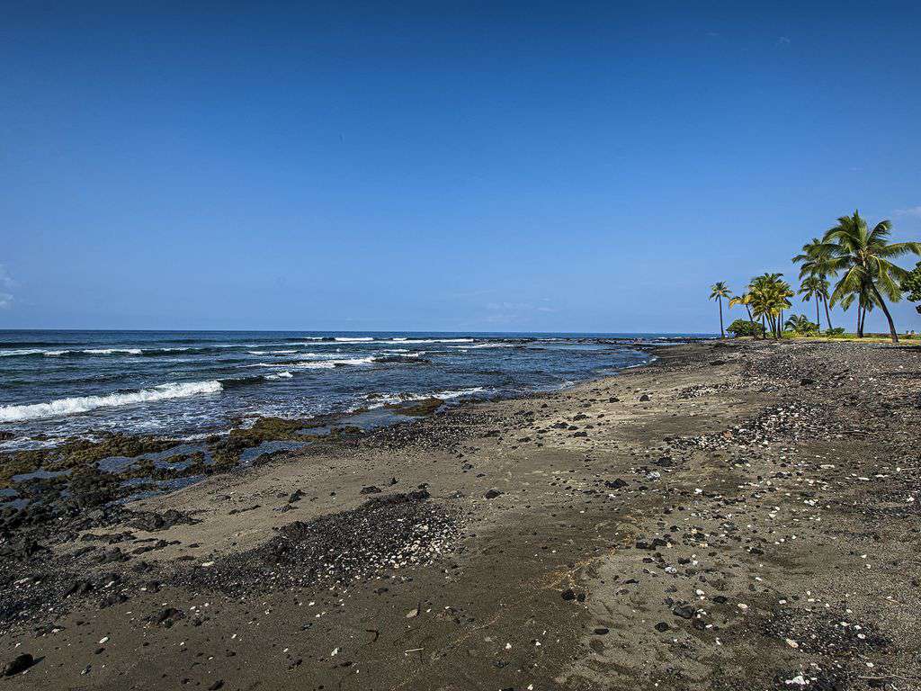 Sandy/gravel beach located within the Surf & Racquet property on the north end.