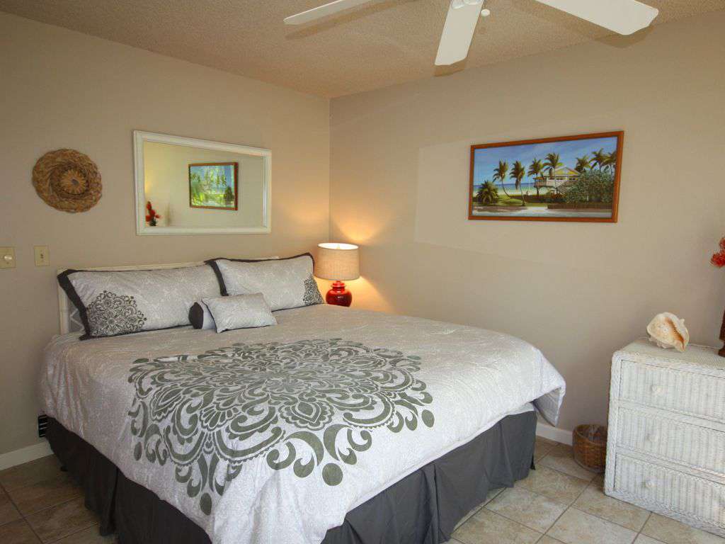 Guest bedroom with king bed and a garden view.