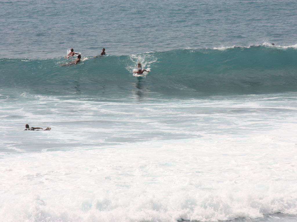 Surfers delight at the popular "Banyans" surf spot.