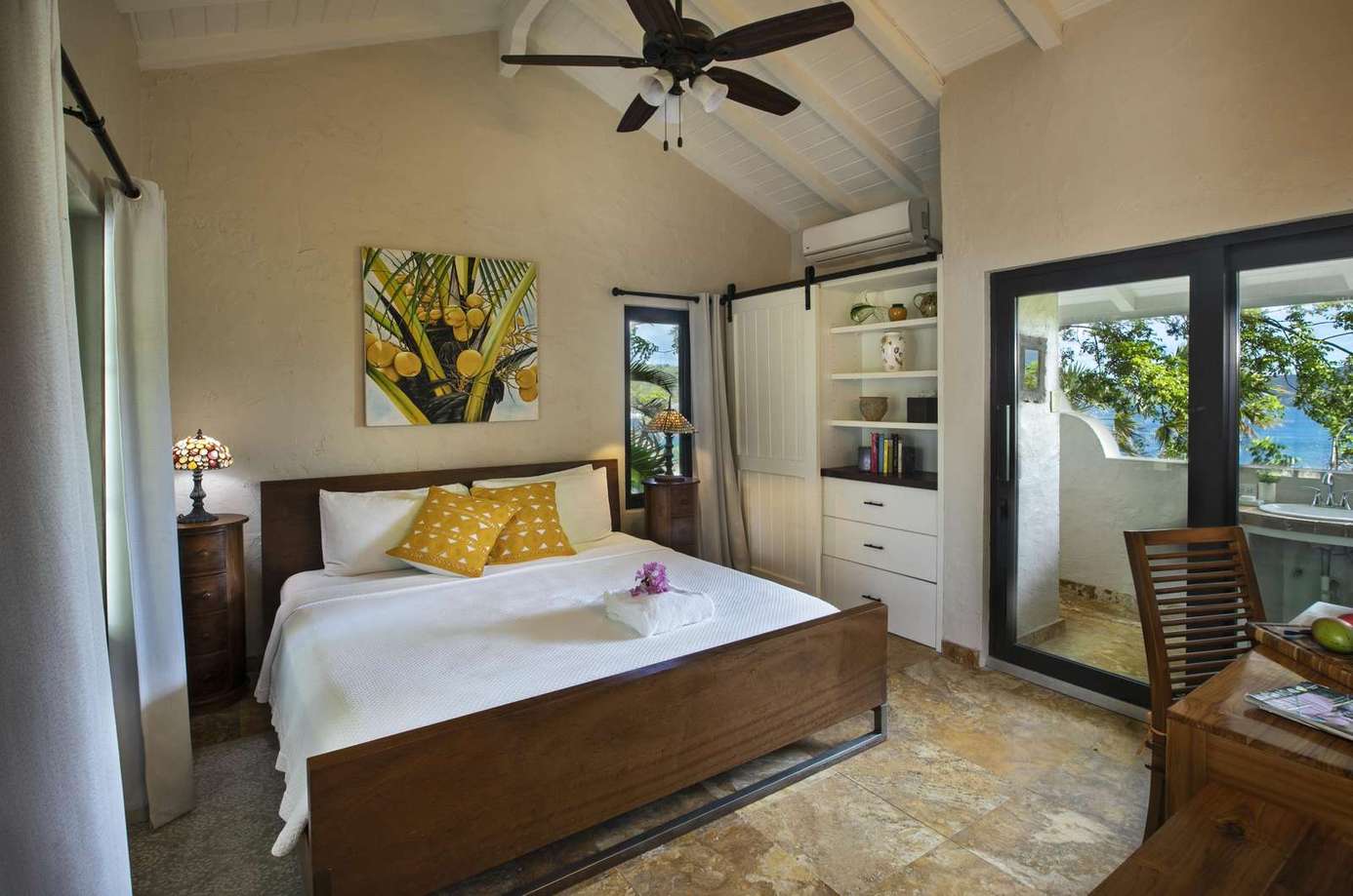 Sunlit bedroom with private balcony and cozy decor