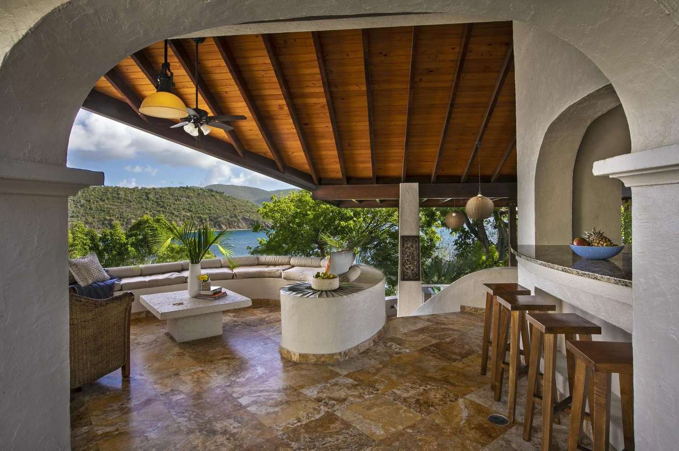 Spacious covered patio with cozy seating and mountain views