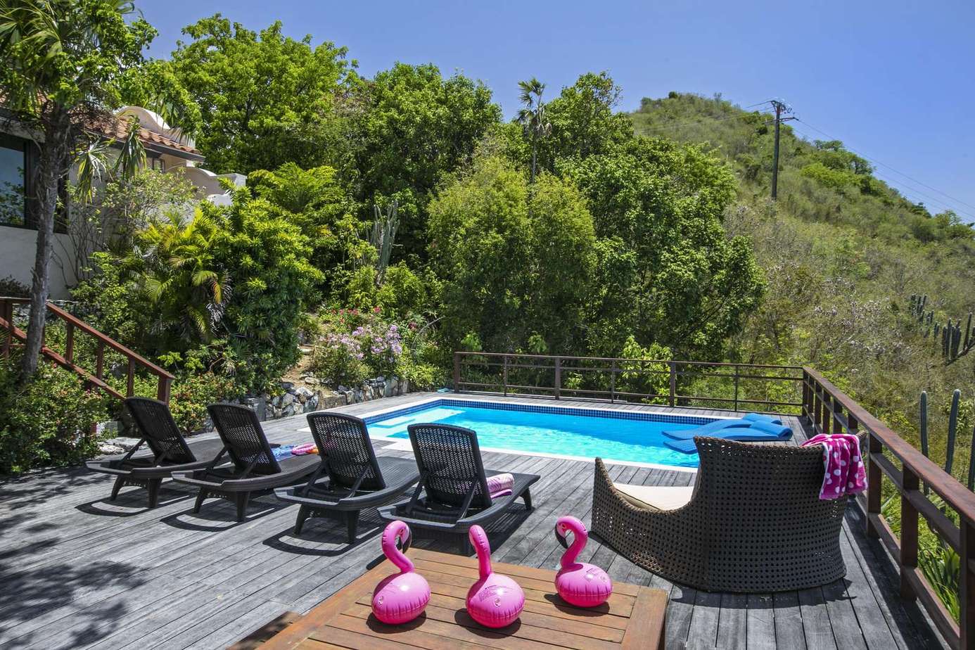 Sun-soaked deck with pool and vibrant outdoor seating
