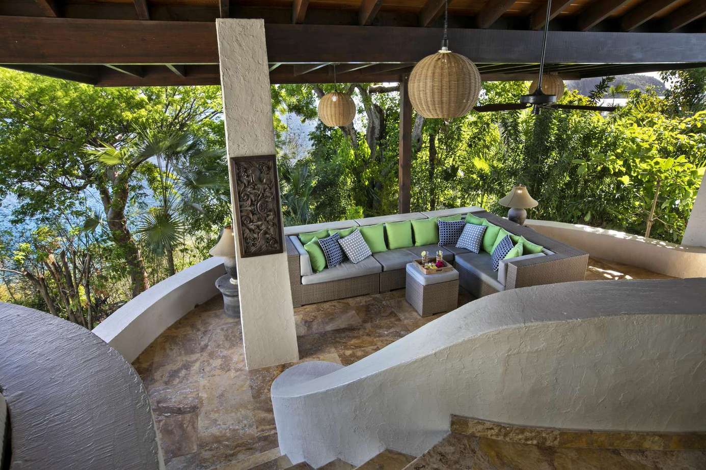 Cozy outdoor lounge surrounded by lush greenery and shade