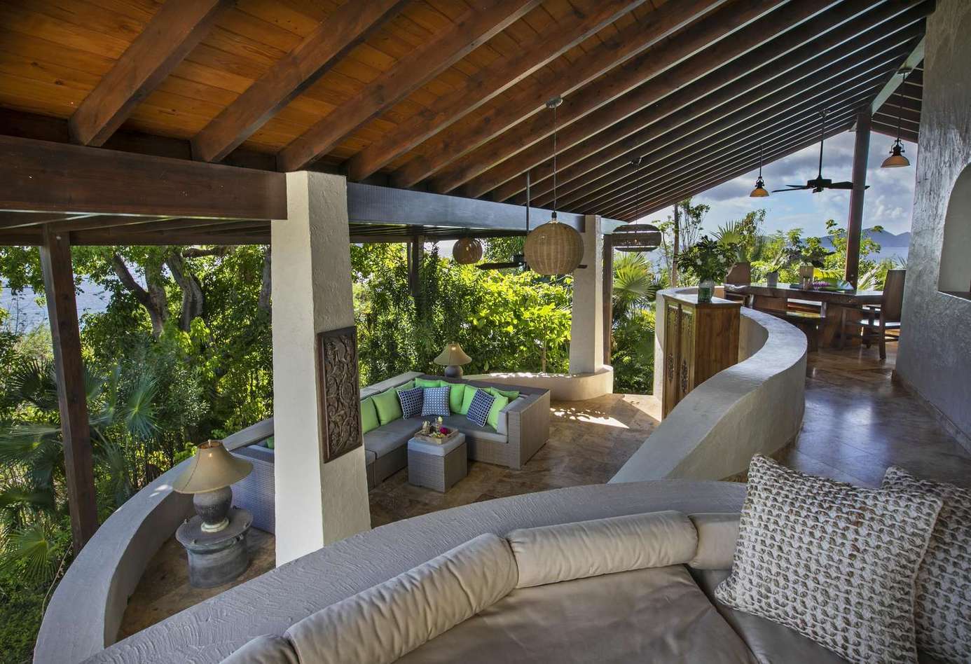 Spacious covered patio with panoramic garden views and cozy seating