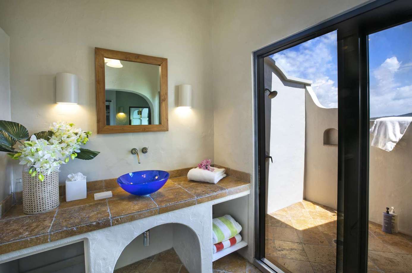 Bright, airy bathroom with refreshing outdoor shower access