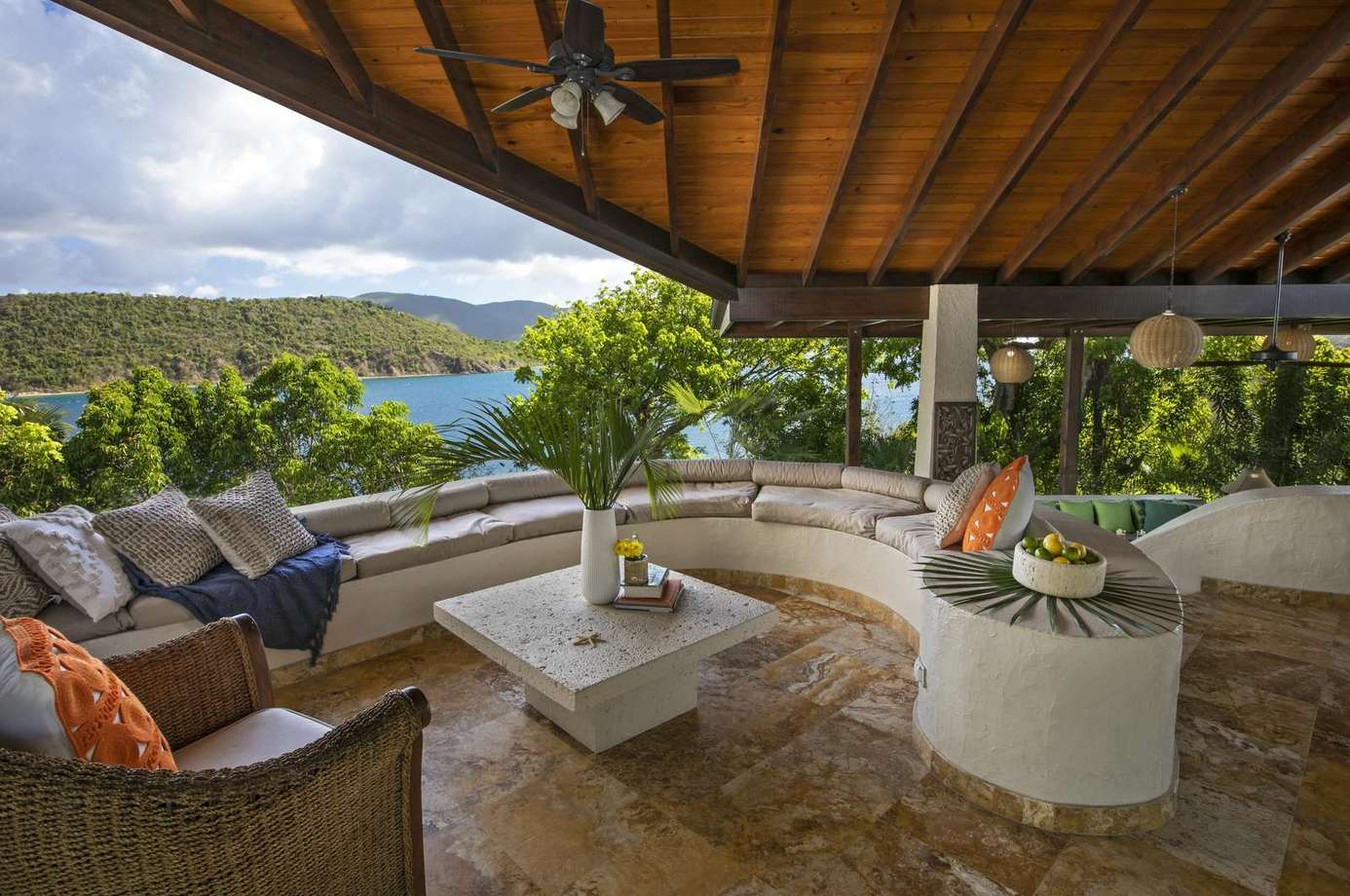 Spacious covered patio with cozy seating and scenic views