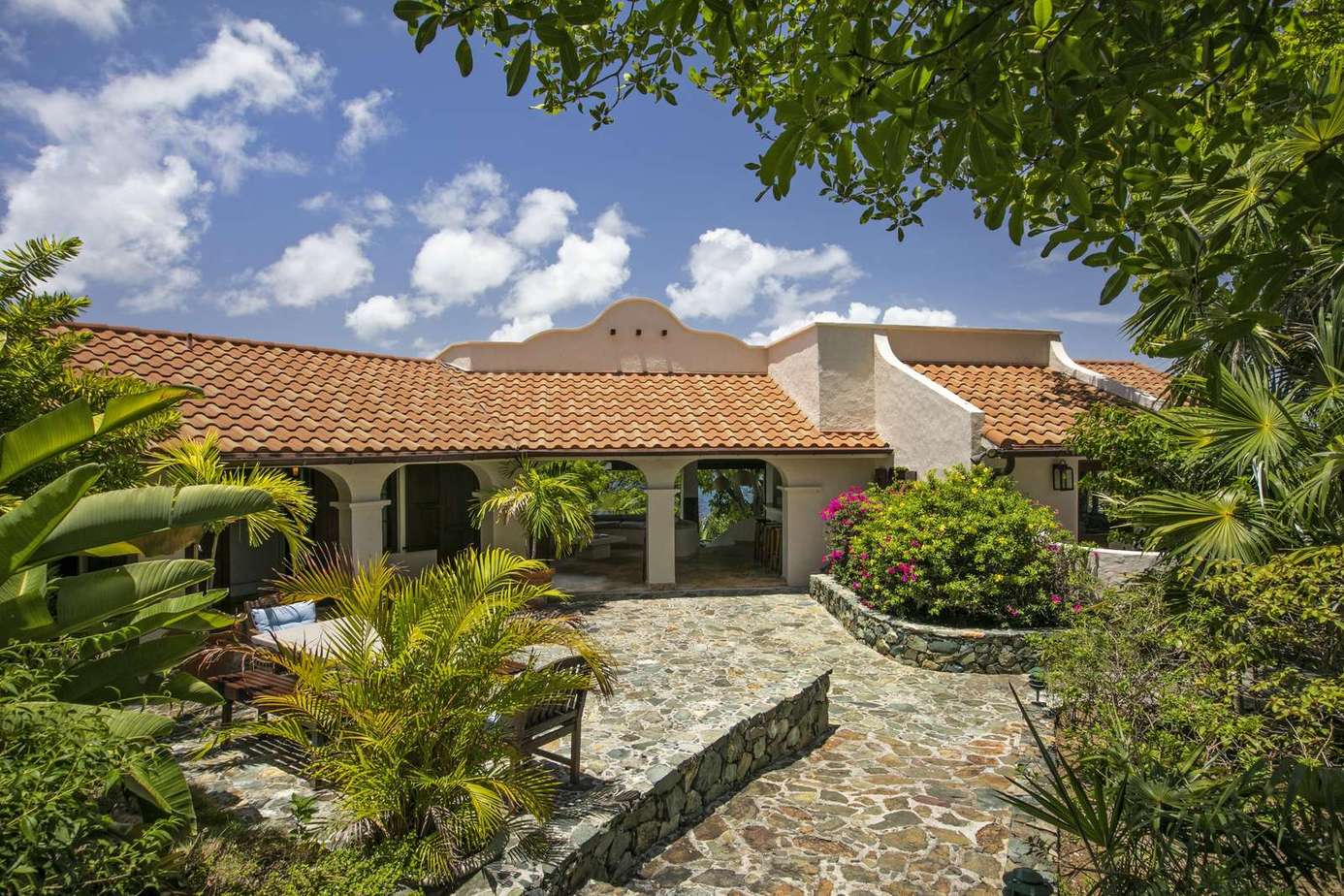 Charming courtyard with lush greenery and rustic stone pathways
