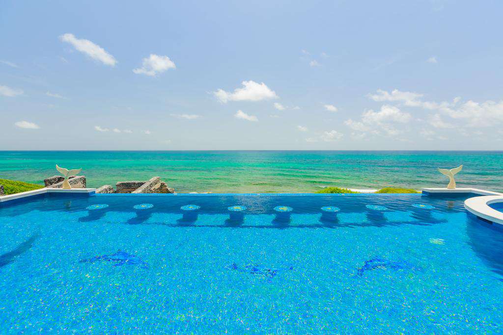 Infinity pool and stools overlooking the Caribbean