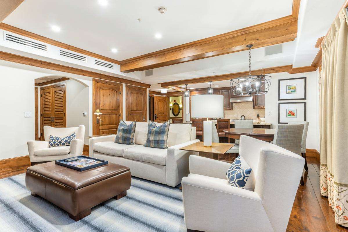 Spacious living room with cozy seating and elegant wood accents - property