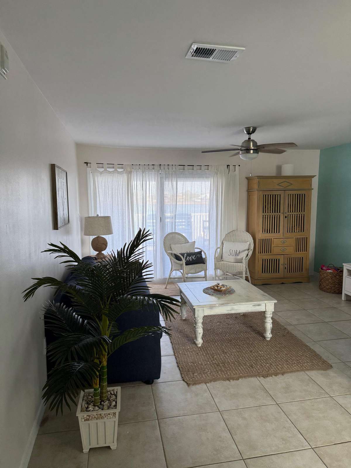 Bright and airy living room with cozy seating and natural light - property