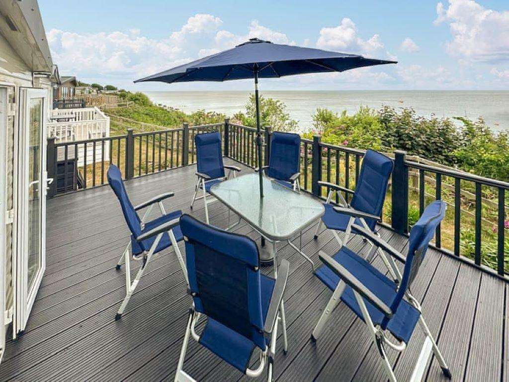 The holiday home’s decking offers panoramic views of the stunning Suffolk Coast. - property