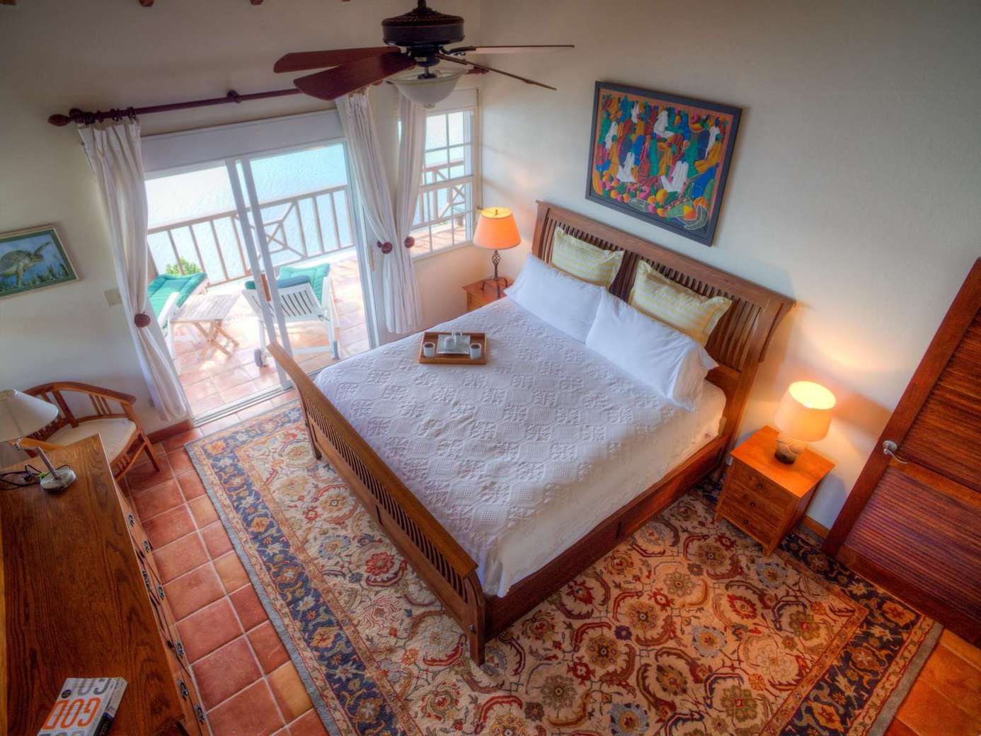 Cozy bedroom with balcony views and warm natural light
