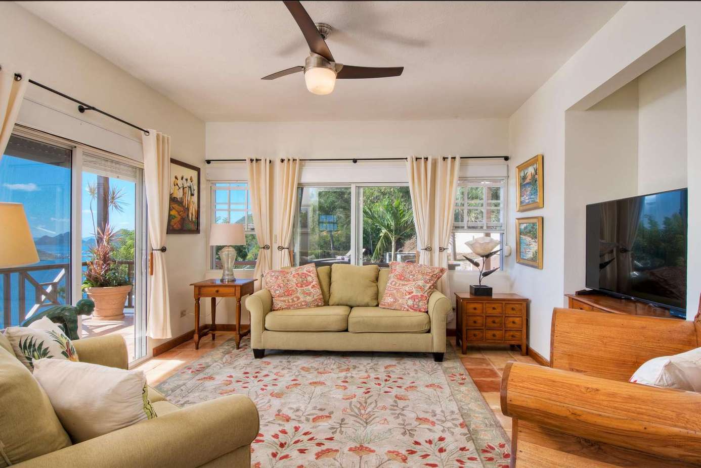 Sunlit living room with cozy seating and scenic views