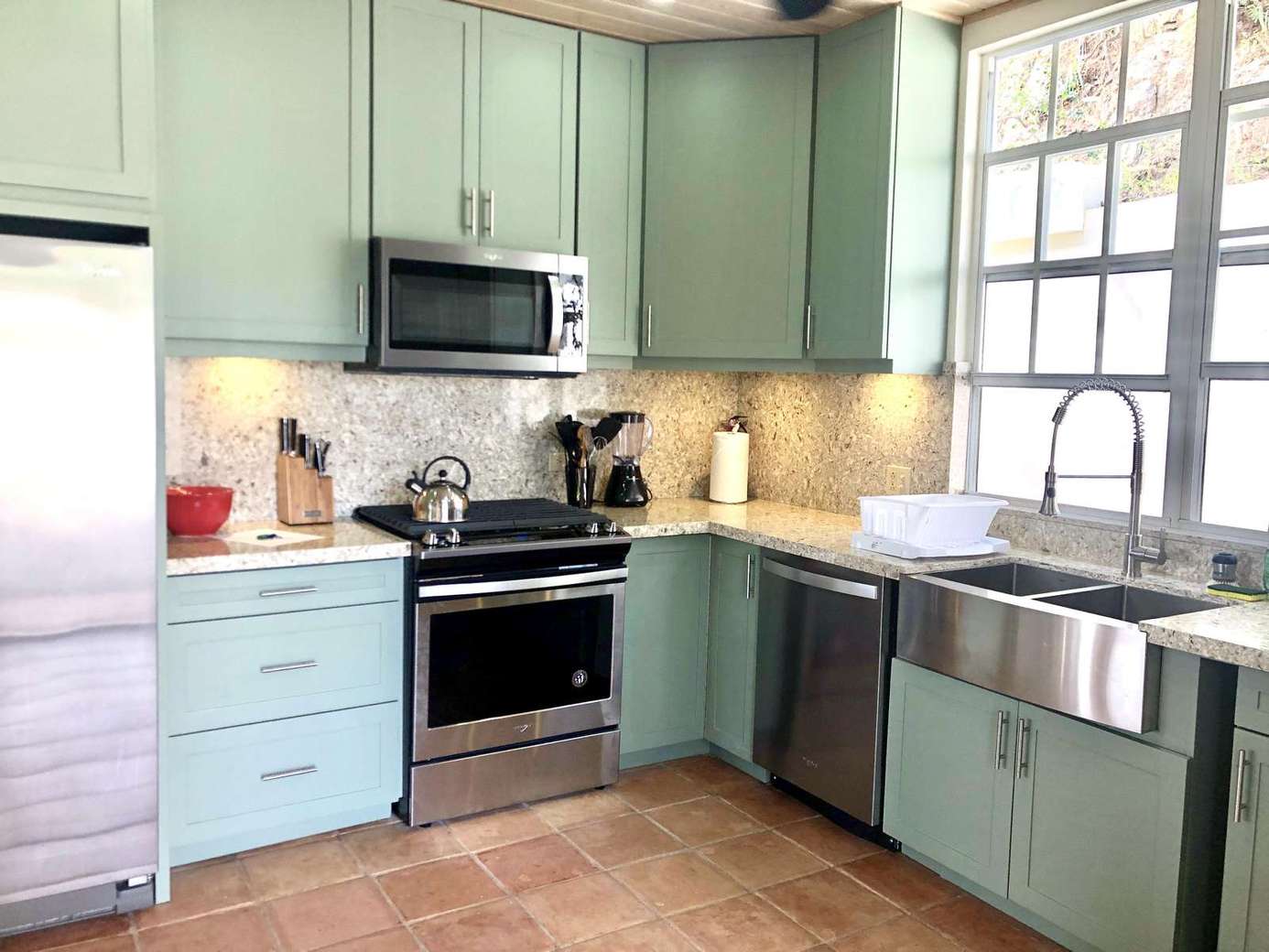 Bright kitchen with farmhouse sink and pastel cabinetry