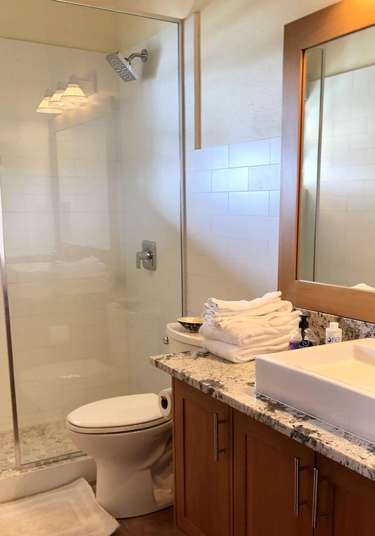 Bright, modern bathroom with spacious glass shower and elegant vanity