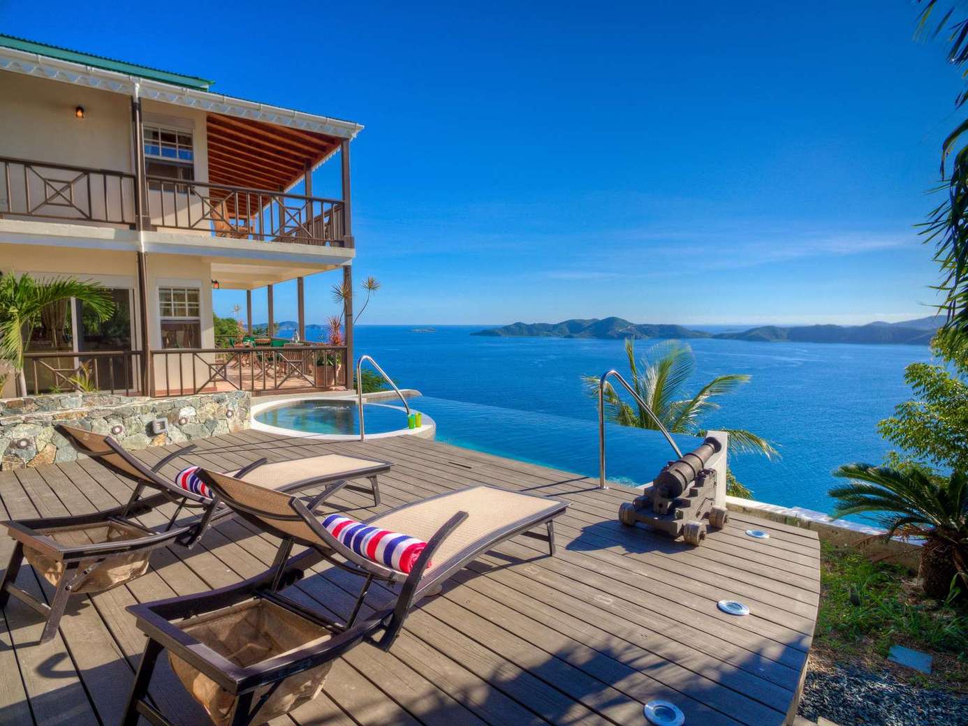 Sun-soaked patio with panoramic ocean views and spa