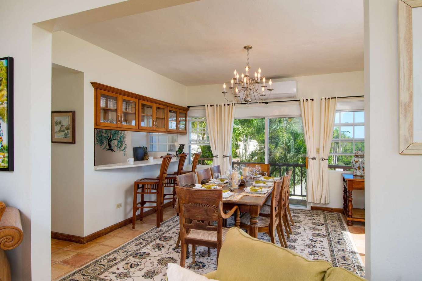 Sunlit dining area with cozy seating and garden views