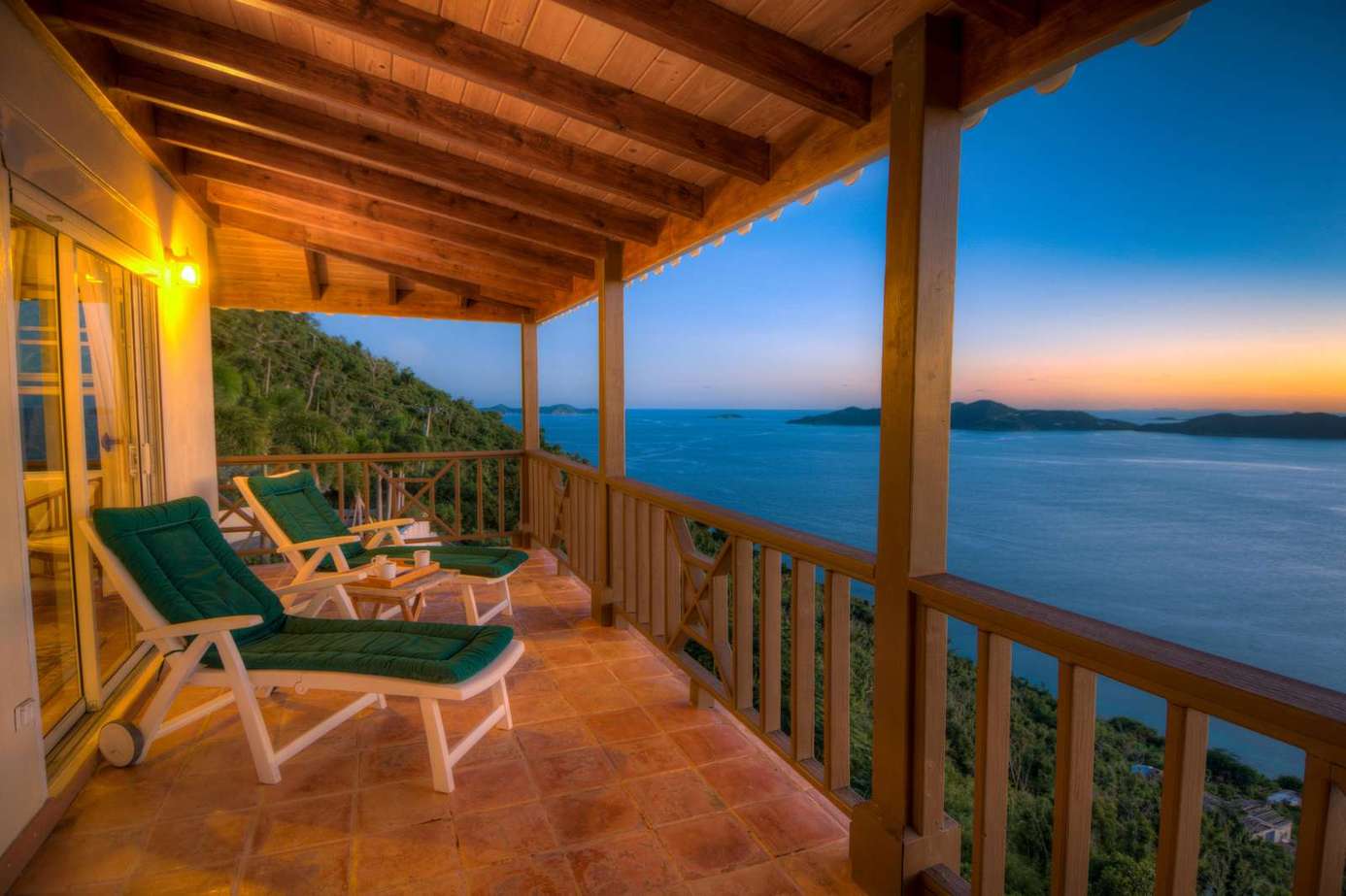 Sunset views from a cozy oceanfront balcony retreat