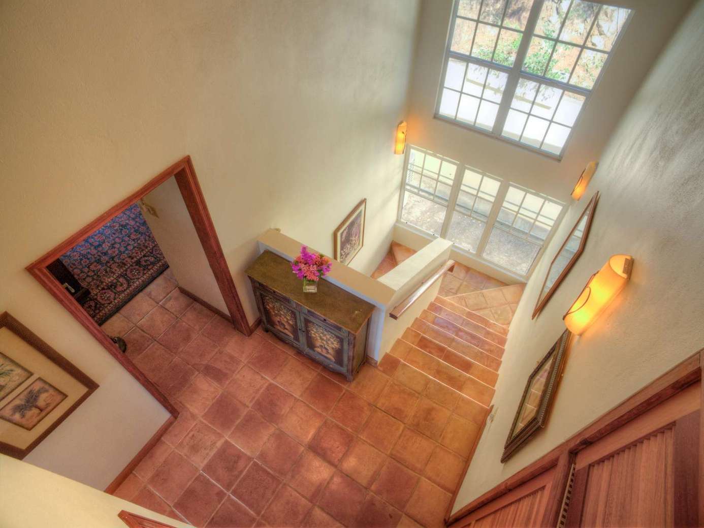 Sunlit entryway with warm tile flooring and cozy charm
