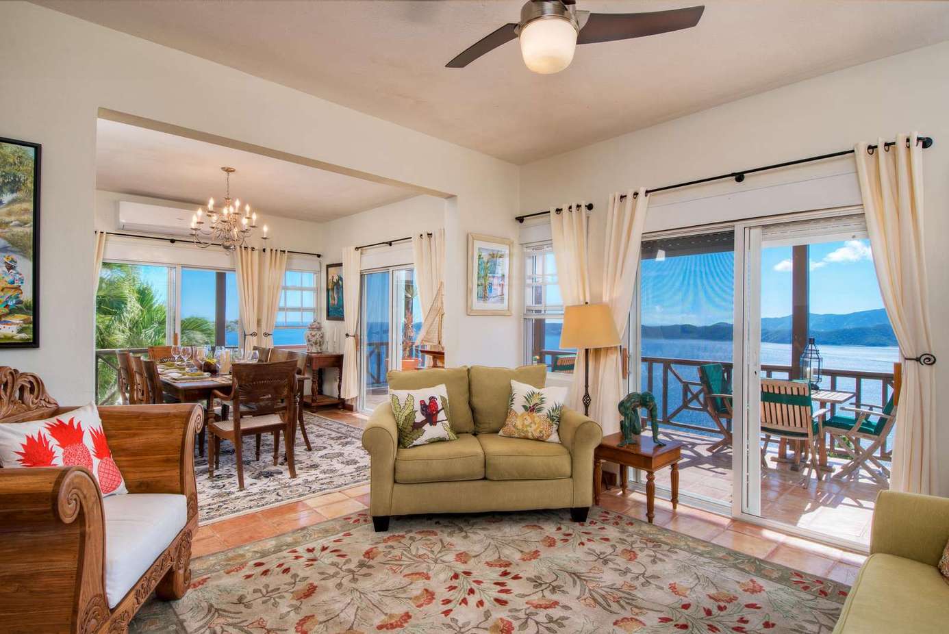 Sunlit living room with ocean views and cozy seating