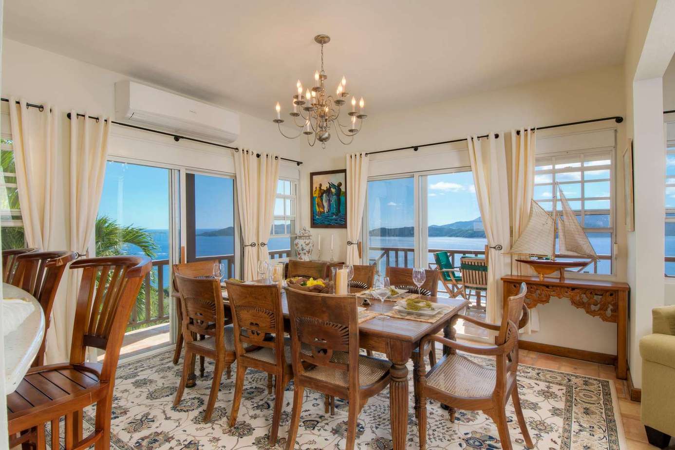 Sunlit dining room with panoramic ocean views and elegant decor