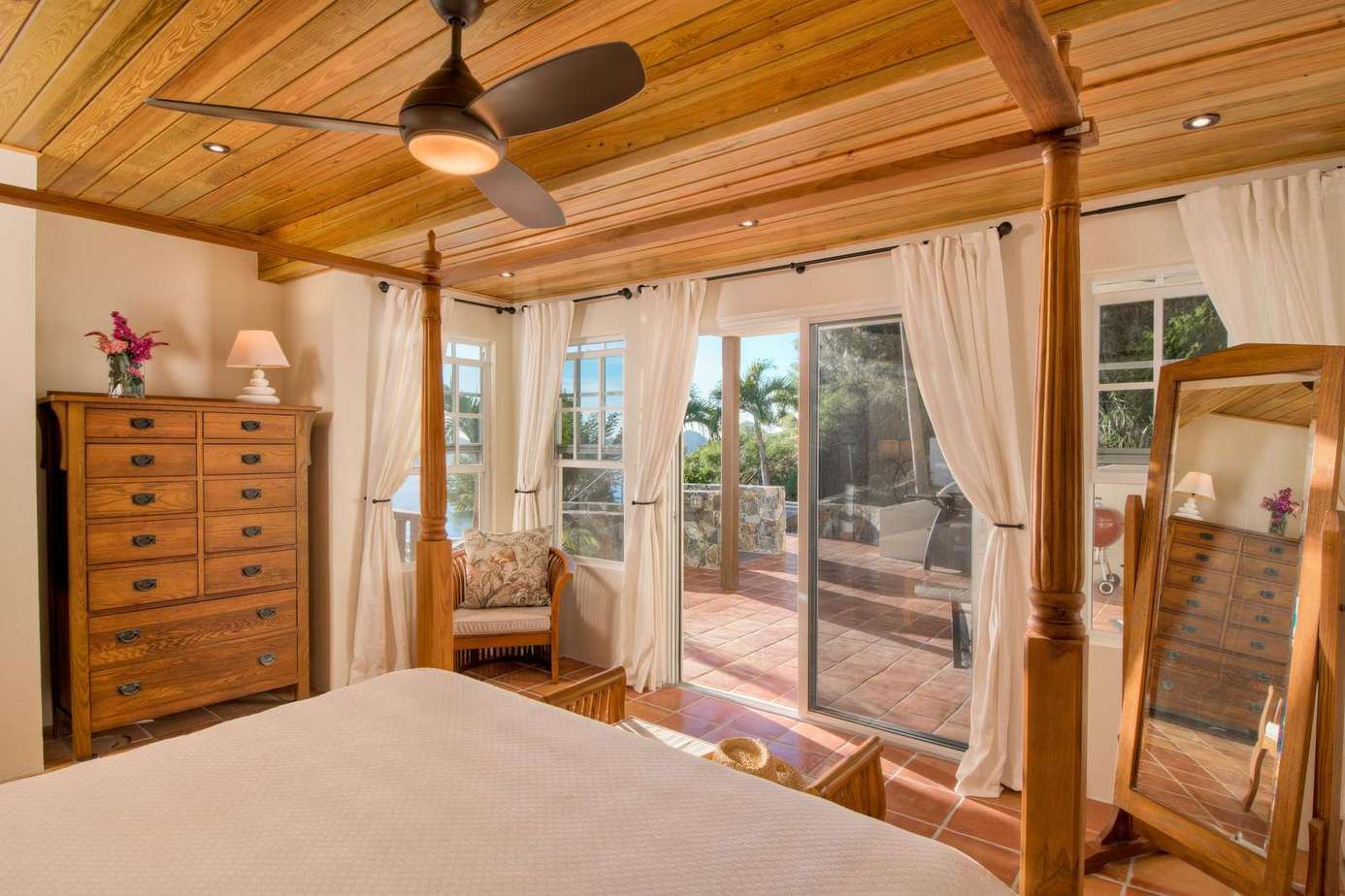Sunlit bedroom with cozy wooden accents and patio access