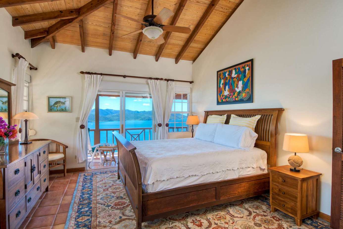 Spacious bedroom with vaulted ceilings and ocean views