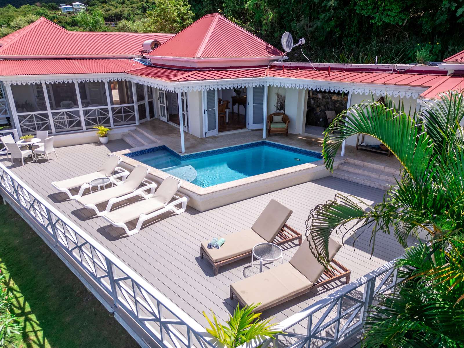 Sun-soaked poolside patio with ample lounge seating - property