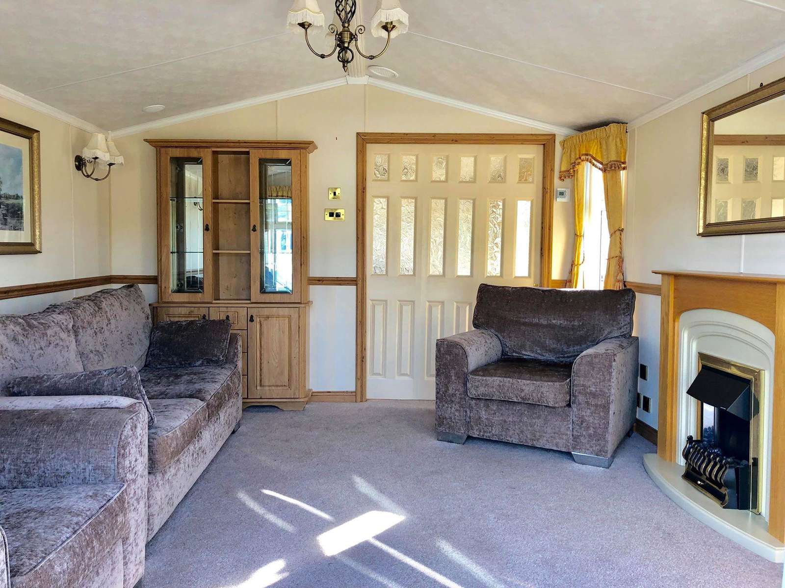 A very homely lounge with an electric fire and smart TV with complimentary wifi!
