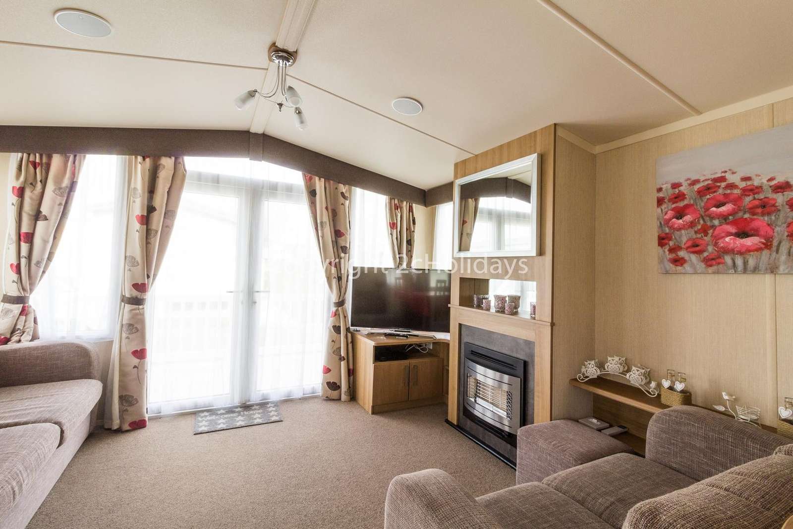 A homely and light living area with double doors leading to the decking area