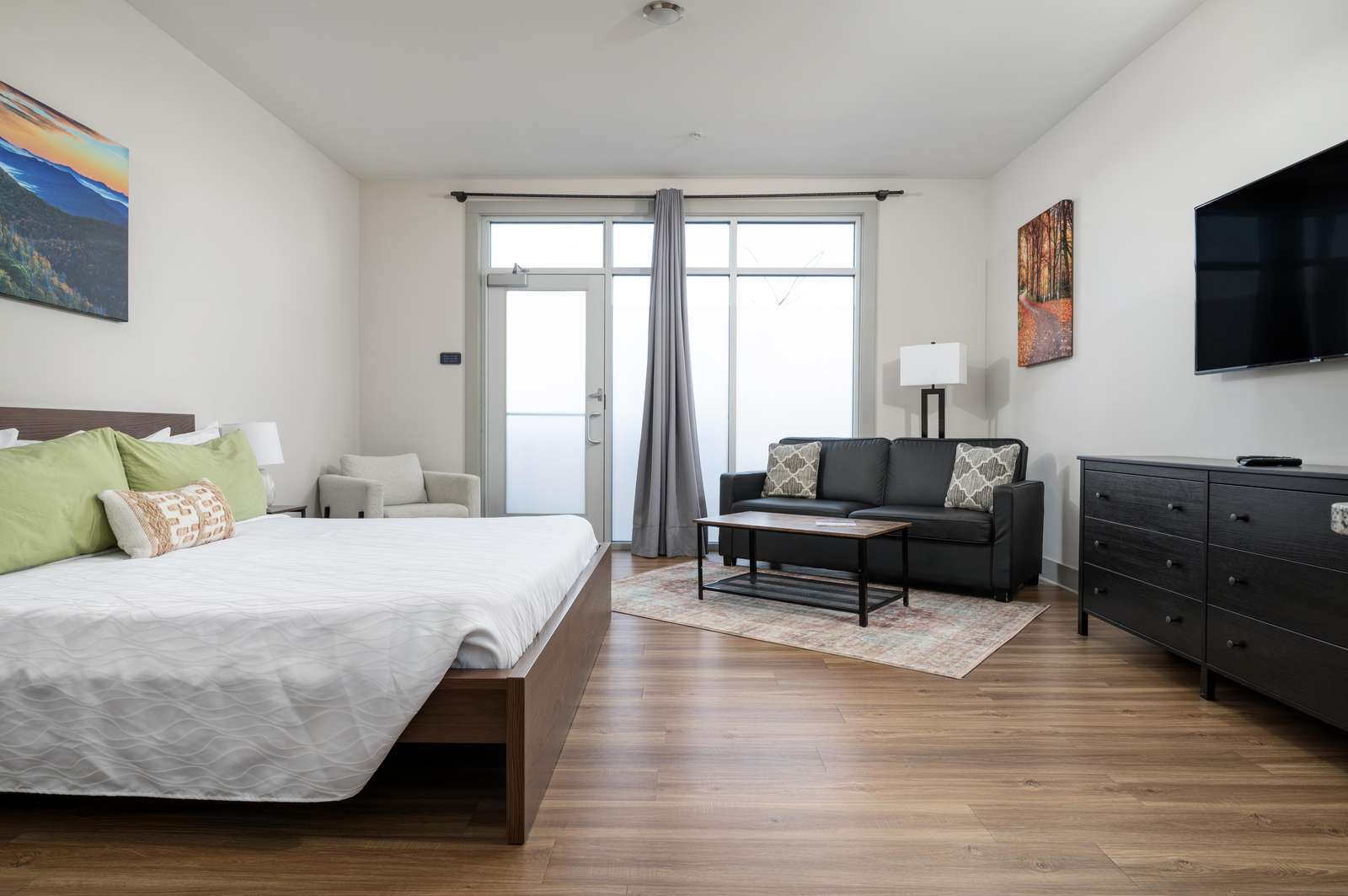 Bright and airy bedroom with cozy seating and natural light - property