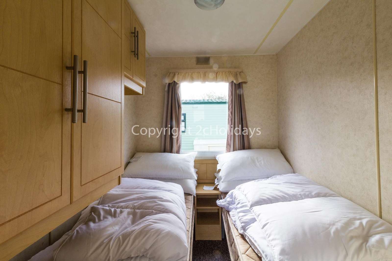 Cosy and comfortable twin bedroom with plenty of storage