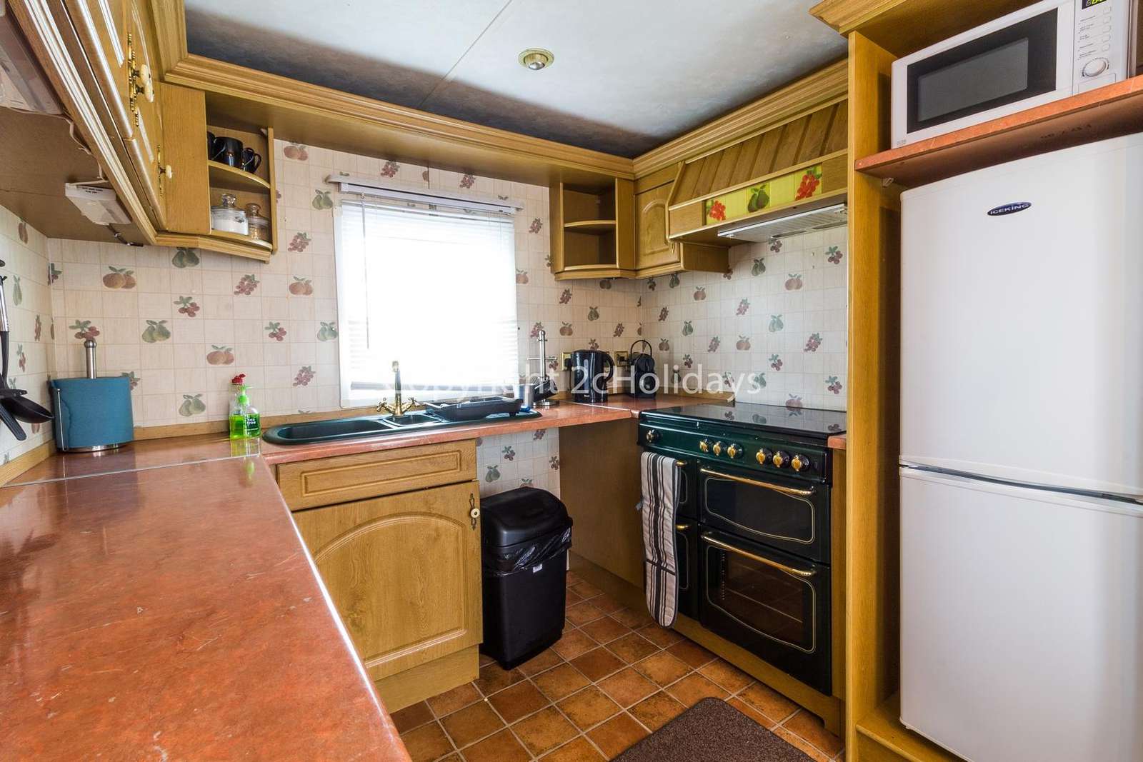This kitchen includes a full size oven/hob and full size fridge/freezer!