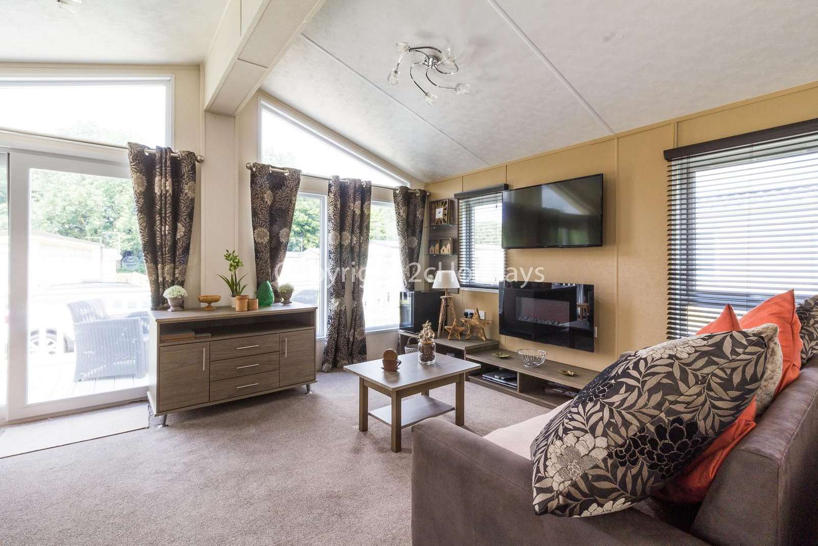 Beautiful light lounge with sliding doors leading onto the decking area