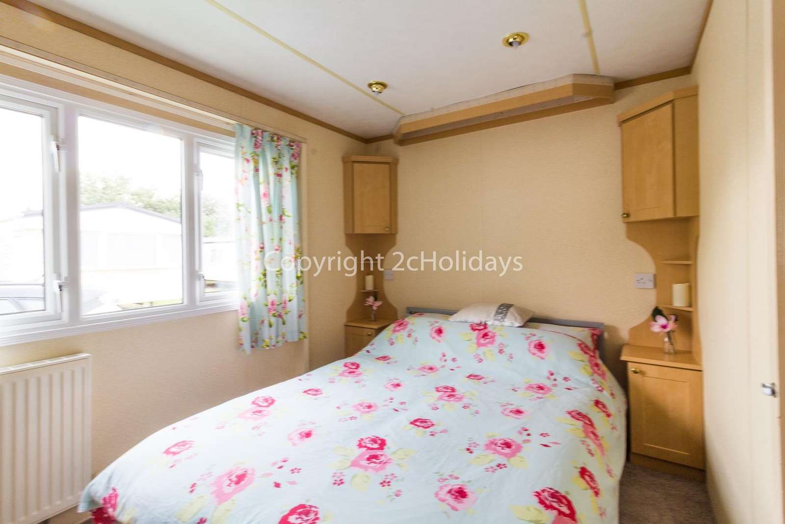 Theres plenty of space in this mater bedroom for a travel cot if needed