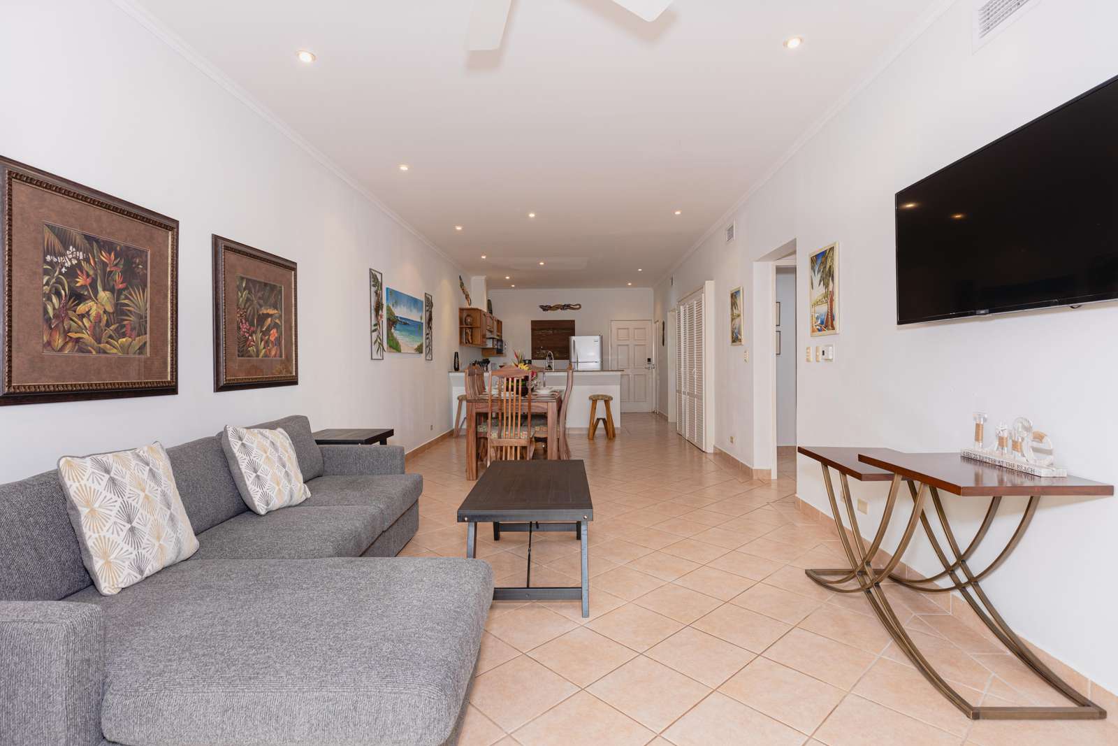 View of living area, smart TV, access to dining and kitchen