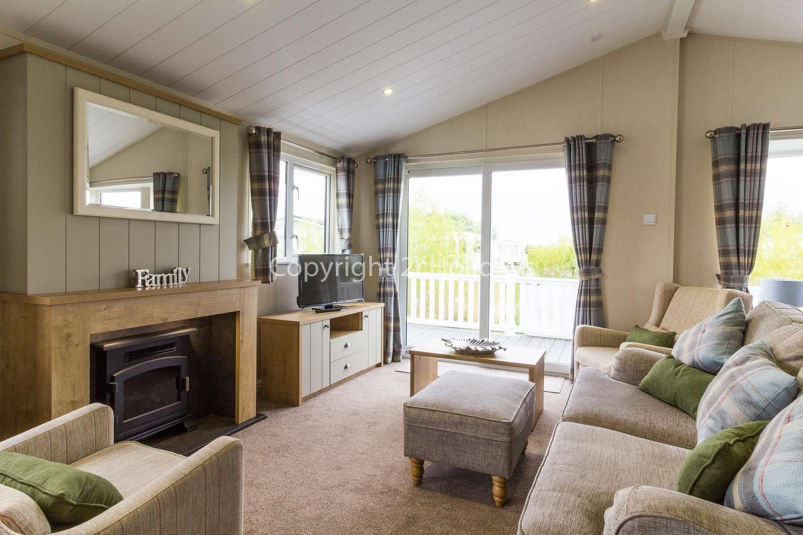 Modern lounge with double doors leading to the decked area!