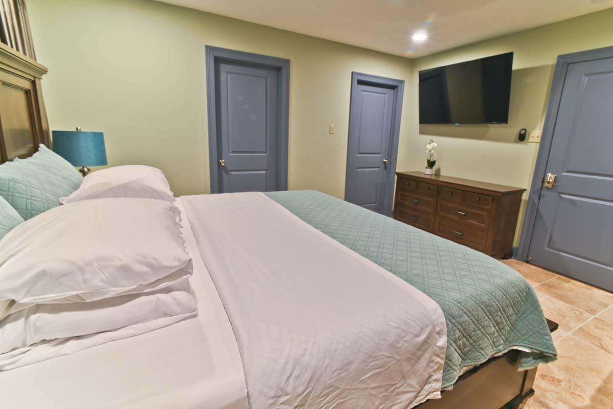 Master bedroom showing private bathroom door left and walk in closet at middle