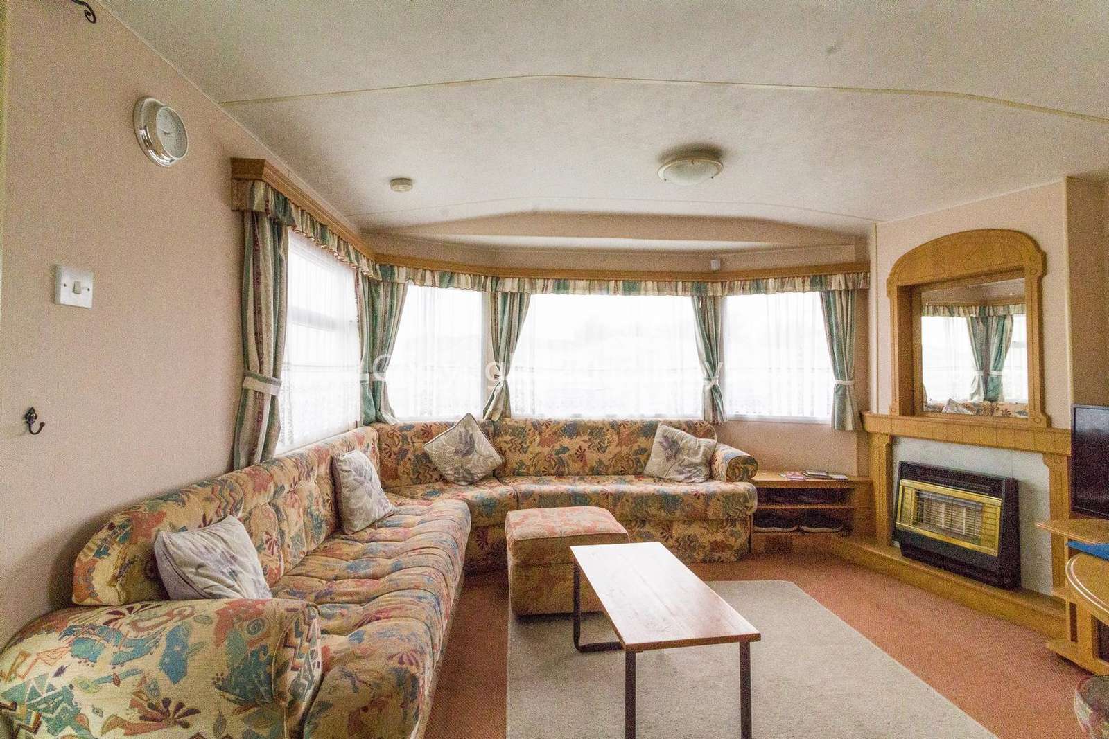 Spacious living area with a TV and gas fire