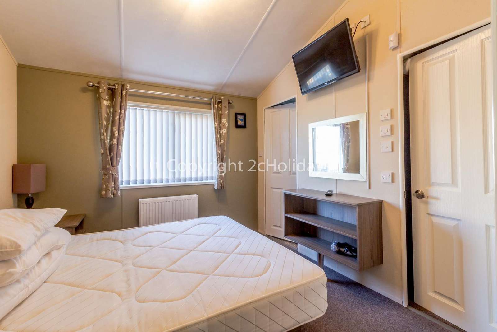 You can find a TV and walk in wardrobe with ample